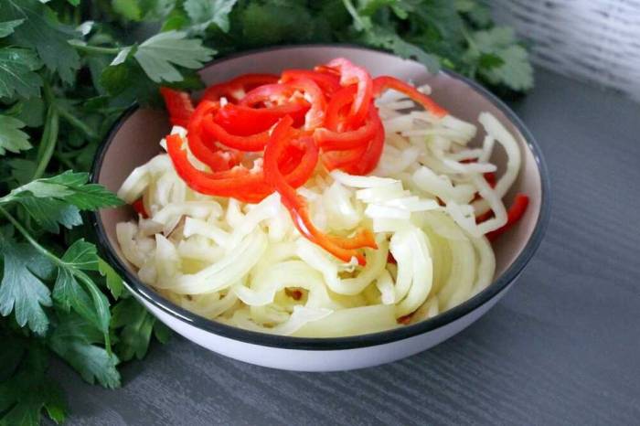 Лук и болгарский перец нарезаны полукольцами Нарезанные полукольцами лук и перец