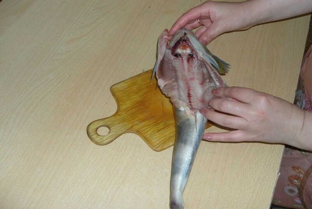 Выпотрошенная тушка рыбы терпуг На деревянной доске выпотрошенная тушка рыбы