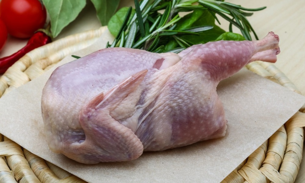 Ощипанная тушка перепёлки Тушка перепёлки на столе