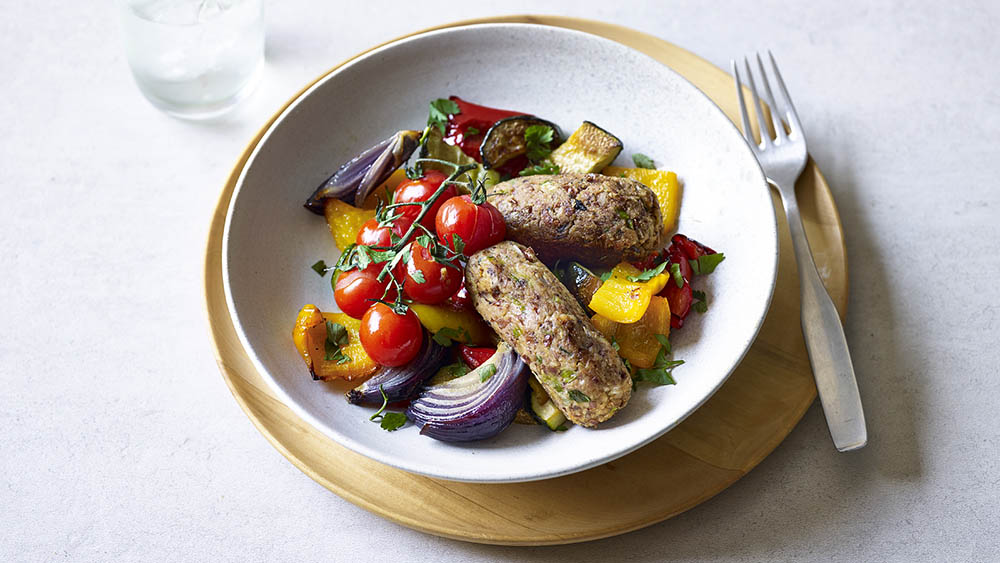 Употребление вегетарианских колбасок с овощами Вегетарианские колбаски на тарелке